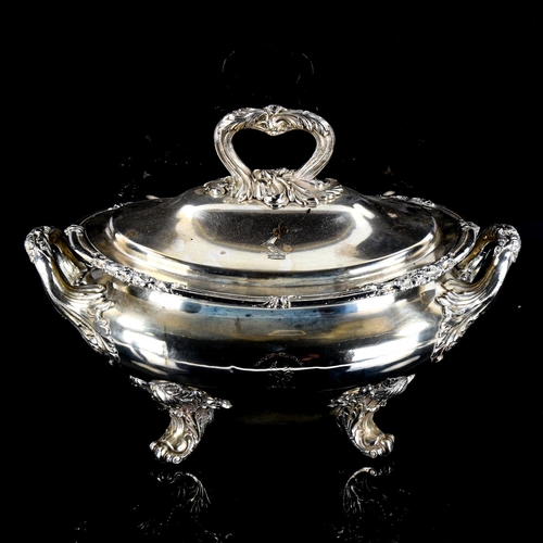 1144 - A large silver plated 2-handled soup tureen and cover, with cast foliate decoration on scrolled acan... 