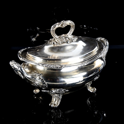 1144 - A large silver plated 2-handled soup tureen and cover, with cast foliate decoration on scrolled acan... 