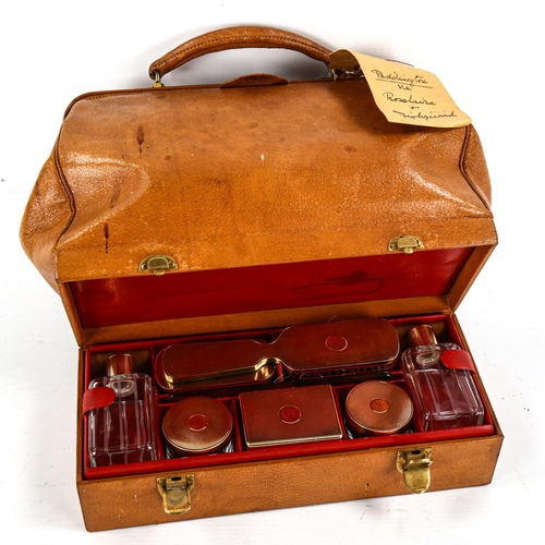 1162 - CARTIER - a Vintage tan leather travelling case, the base opening to reveal a set of fine quality cu... 