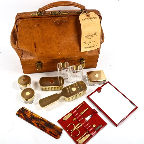 1162 - CARTIER - a Vintage tan leather travelling case, the base opening to reveal a set of fine quality cu... 