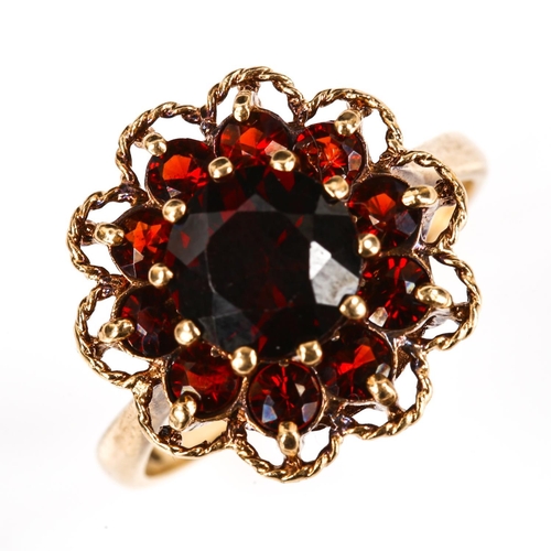 261 - A late 20th century 9ct gold garnet cluster flowerhead ring, set with round-cut garnets, hallmarks L... 