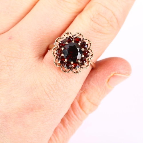 261 - A late 20th century 9ct gold garnet cluster flowerhead ring, set with round-cut garnets, hallmarks L... 