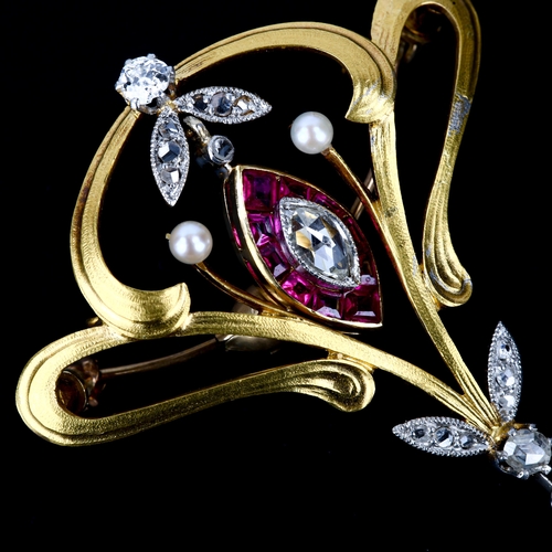 100 - A French Art Nouveau gold ruby pearl and diamond openwork brooch, centrally suspending a marquise cl... 