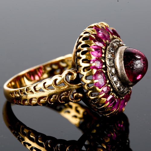 106 - An Antique ruby and diamond cluster ring, unmarked gold settings, set with central high cabochon rub... 