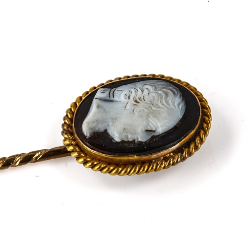 110 - An Antique hardstone cameo stickpin, unmarked gold settings, with relief carved male head profile, s... 