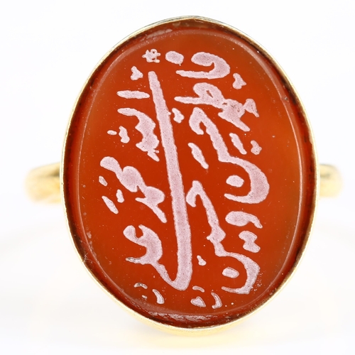 417 - An Arabic script carnelian seal ring, unmarked gilt-metal settings, setting height 20.2mm, size M, 3... 