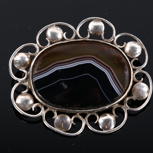 421 - An Arts and Crafts unmarked silver and banded agate brooch, length 54.2mm, 14.2g