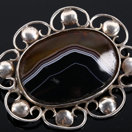 421 - An Arts and Crafts unmarked silver and banded agate brooch, length 54.2mm, 14.2g