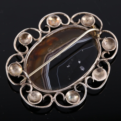 421 - An Arts and Crafts unmarked silver and banded agate brooch, length 54.2mm, 14.2g