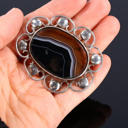 421 - An Arts and Crafts unmarked silver and banded agate brooch, length 54.2mm, 14.2g