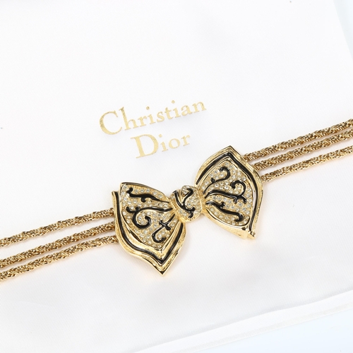 439 - CHRISTIAN DIOR - a Vintage gold plated ribbon bow tie necklace, black enamel and paste accents, leng... 