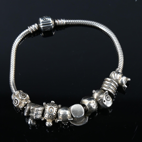 451 - PANDORA - a modern sterling silver snake link charm bracelet, with 9 silver charms, bracelet length ... 