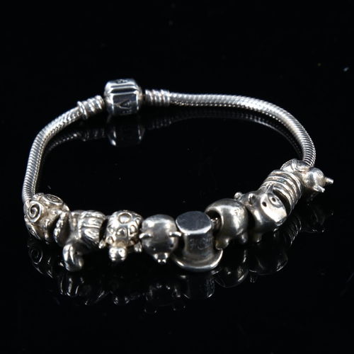 451 - PANDORA - a modern sterling silver snake link charm bracelet, with 9 silver charms, bracelet length ... 