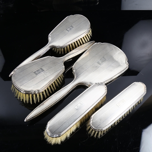 466 - A cased George VI silver dressing table set, comprising hand mirror, 2 x hair brushes, 2 x clothes b... 