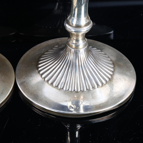 470 - A pair of Continental sterling silver table candlesticks, fluted decoration with cruciform maker's m... 