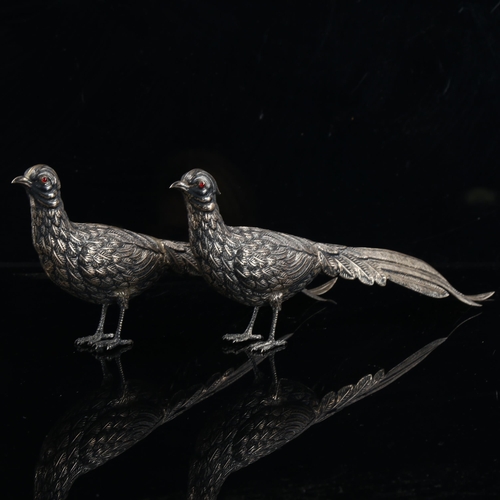 473 - A pair of Continental silver table pheasants, with cabochon red glass eyes, marks on tail feathers, ... 