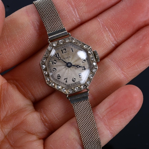 10 - A lady's Art Deco 18ct white gold diamond cocktail bracelet watch, by Genex, engine turned octagonal... 