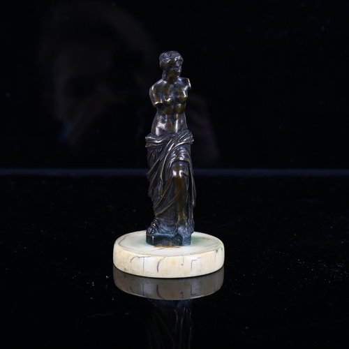 1246 - A 19th century miniature patinated bronze sculpture of Venus on ivory base, height 9cm