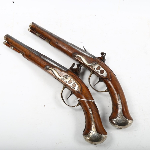 1267 - A pair of 18th century French flintlock pistols, with engraved decoration and ram rods, length 39cm