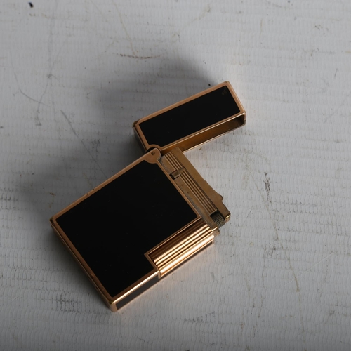 1275 - DUPONT - a gold plated and black enamel pocket lighter, length 5.5cm