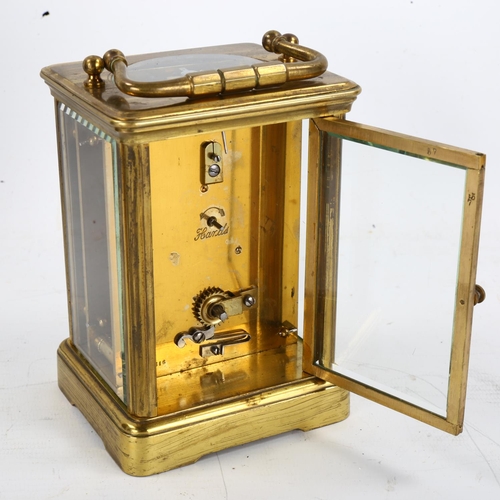 64 - A large brass-cased carriage clock, white enamel dial with Roman numeral hour markers, case height 1... 