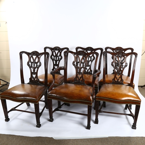 1151 - A set of 12 Chippendale style mahogany dining chairs, with carved and pierced backs and brass studde... 