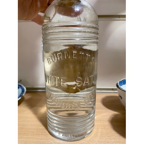 1120 - A mid 1950s' bottle of Burnett's White Satin Gin, with spring top fastening, 70% proof.