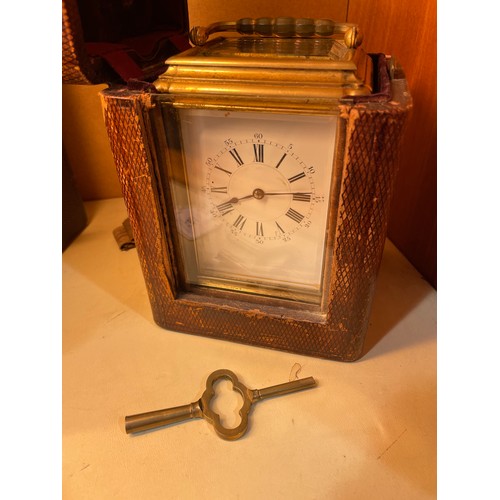 62 - A large French brass-cased carriage clock, white enamel dial with Roman numeral hour markers and exh... 