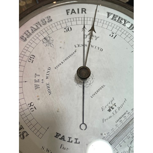 1054 - A Victorian Keen & Frodsham combination barometer / thermometer, in original metal case with bevelle... 