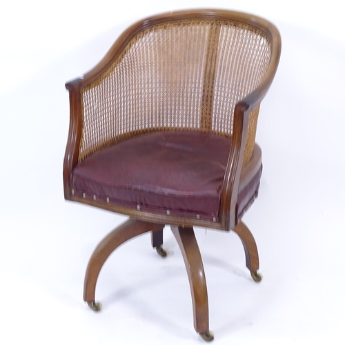 2007 - An early 20th century red leather upholstered and cane-backed bow-arm desk chair