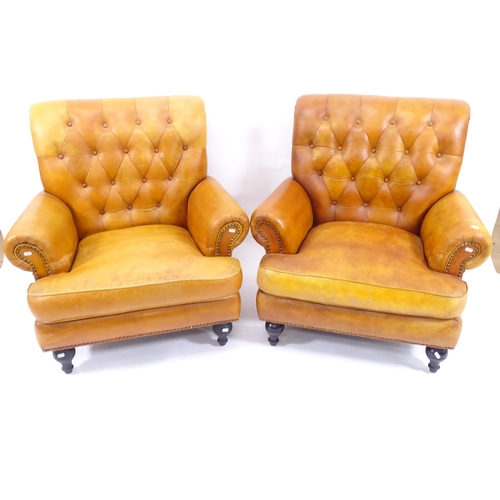 2014 - A pair of modern brown leather upholstered armchairs