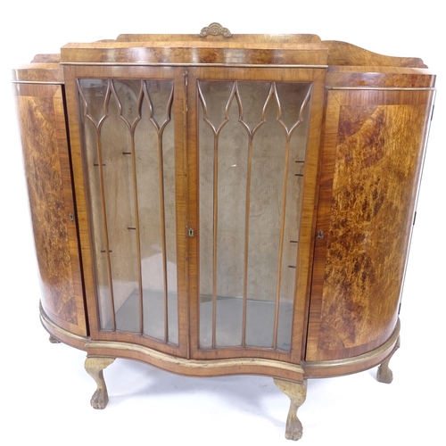 2017 - A 1930s walnut 4-door display cabinet of serpentine form, W150cm, H135cm, D46cm