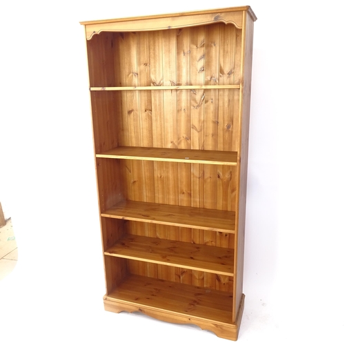 2030 - A polished pine open bookcase with 4 adjustable shelves, W95cm, H190cm, D32cm