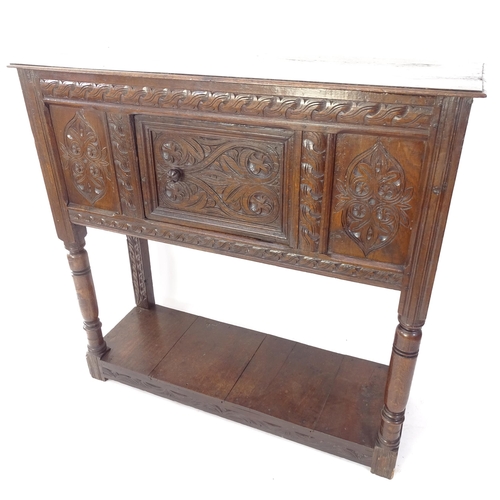 2031 - An Antique oak cabinet on stand, with allover relief carved panelled decoration, single cupboard doo... 