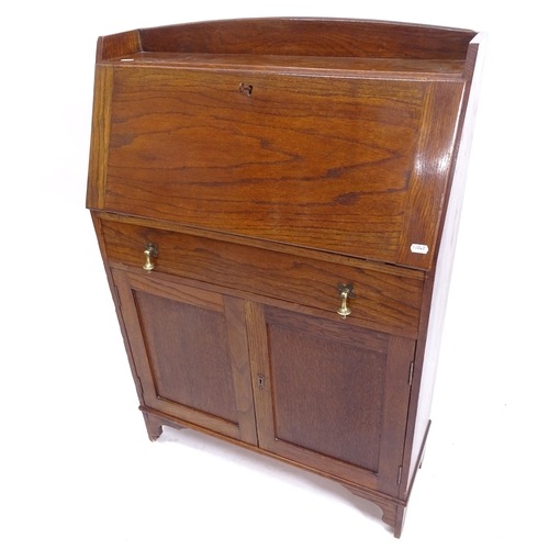 2043 - A small 1920s oak bureau, with cupboard doors under, W71cm, H102cm, D26cm