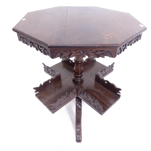 2048 - A Victorian carved oak book table, with octagonal top and rotating shelf below, on tripod base, W56c... 