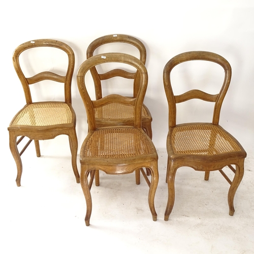 2057 - A set of 4 oak balloon-back dining chairs with cane panelled seats