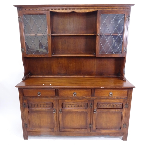 2080 - A modern carved and panelled oak 2-section dresser, base fitted with drawers and cupboards, on stile... 