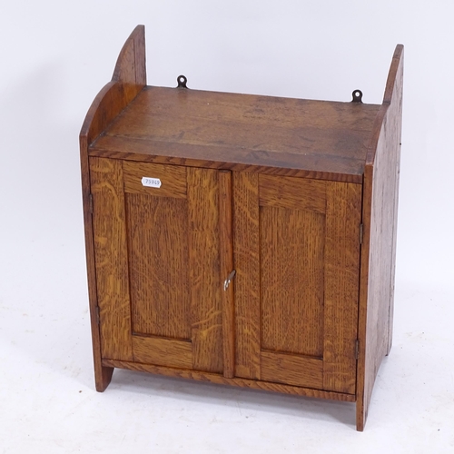 2082 - A small Arts and Crafts oak hanging 2-door cupboard, W37cm, H46cm, D22cm