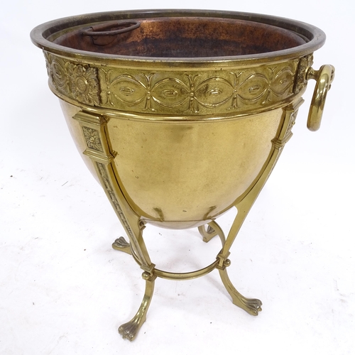 2084 - An embossed brass Adam style coal bucket, on claw feet, with ring handles, W36cm, H46cm