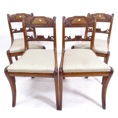 2086 - A set of 4 19th century mahogany sabre leg dining chairs, with carved table-top rails, and upholster... 