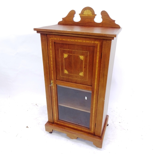 2109 - An Edwardian mahogany and satinwood-banded music cabinet, with single panelled and glazed door, W56c... 