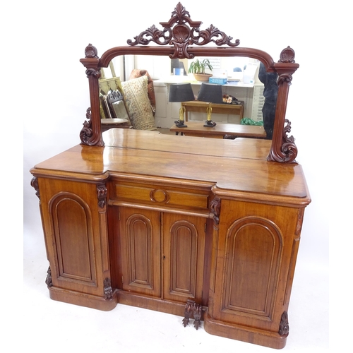 2114 - A Victorian mahogany inverted break-front mirror-back sideboard, with frieze drawer and arch-top pan... 