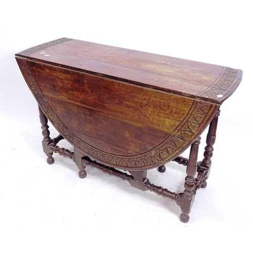 2152 - An Antique oak oval gateleg table, with carved edge, on baluster turned legs, W114cm, H75cm