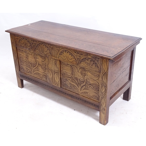 2157 - An Antique oak coffer, with a carved panelled front, on stile legs, W110cm, H57cm, D47cm