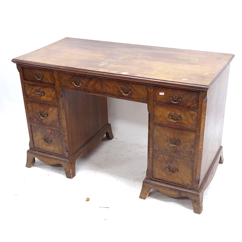 2163 - A walnut crossbanded kneehole writing desk, with fitted drawers, W121cm, H76cm, D59cm, kneehole widt... 