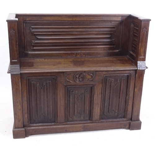 2185 - An Antique oak carved and linenfold panelled hall settle with rising seat, W117cm, H100cm, D41cm