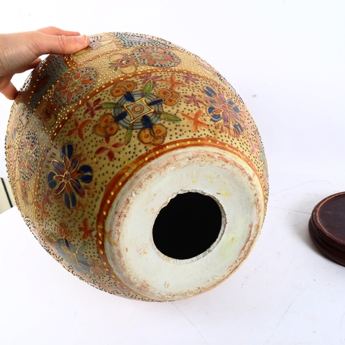 121 - A large Oriental painted and gilded porcelain egg on hardwood stand, height 50cm