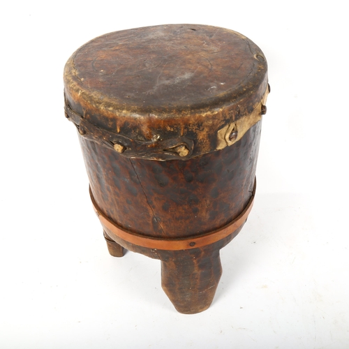 82 - An African Tribal animal skin covered drum, height 38cm