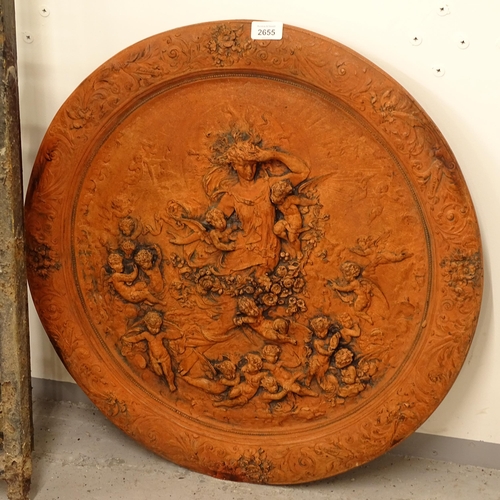 2655 - A terracotta circular wall plaque, depicting a Goddess and cherubs, diameter 60cm